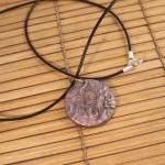 Polymer clay pendant in a c..